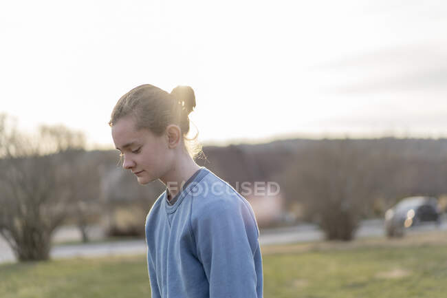 Teenage boy wearing his hair in bun — Stock Photo
