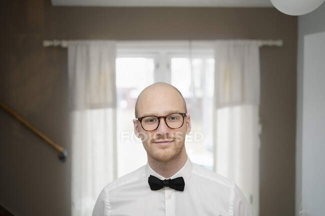 Portrait of bald young man with bow tie — Stock Photo