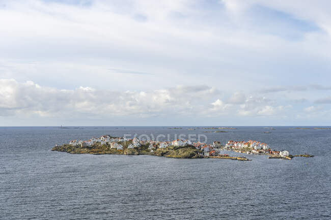 Island on sea under clouds — Stock Photo