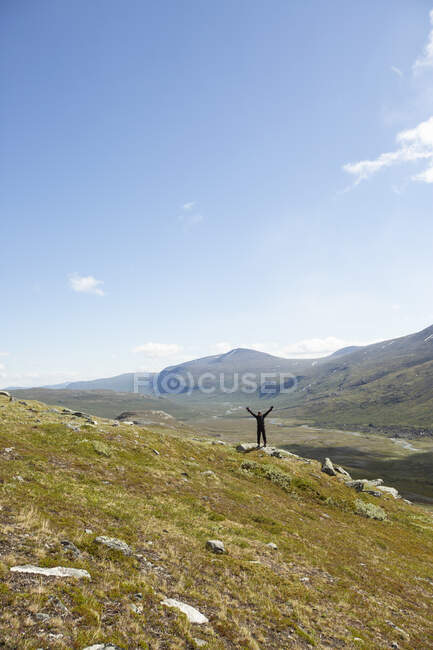 Man celebrating during hike on mountain — Stockfoto