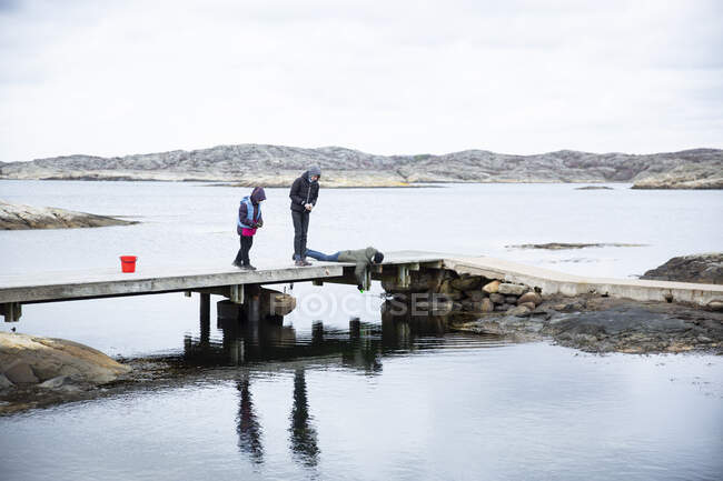 Boys fishing on pier — Stock Photo