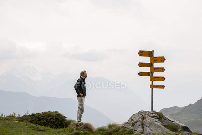 Man by signs on Haute Route, France — Stock Photo