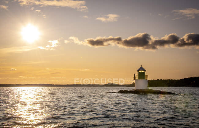 Lighthouse during sunset at Franska Stenarna, Sweden — Stock Photo