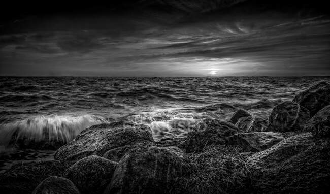 Pedras por mar durante o pôr do sol — Fotografia de Stock