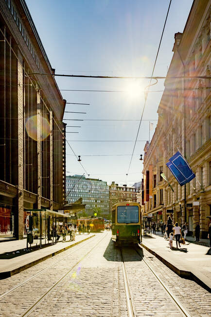 Tram on city street at sunset in Helsinki, Finland — Stock Photo