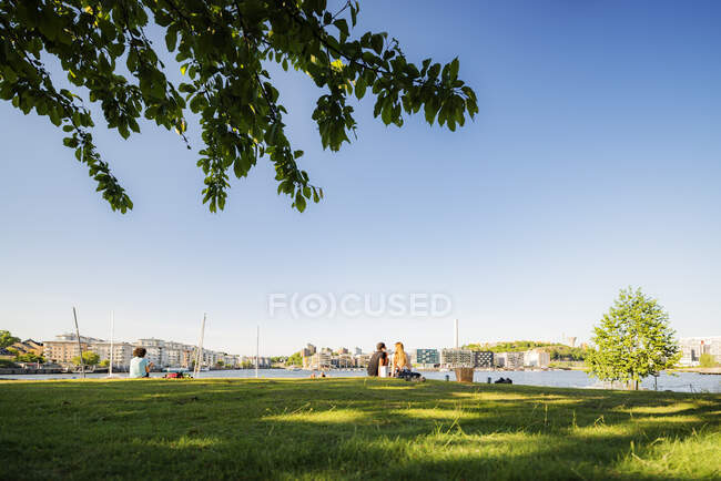 People sitting in grass — Stock Photo