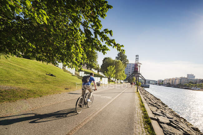 Cyclist by waterfront in Stockholm, Sweden — Stock Photo