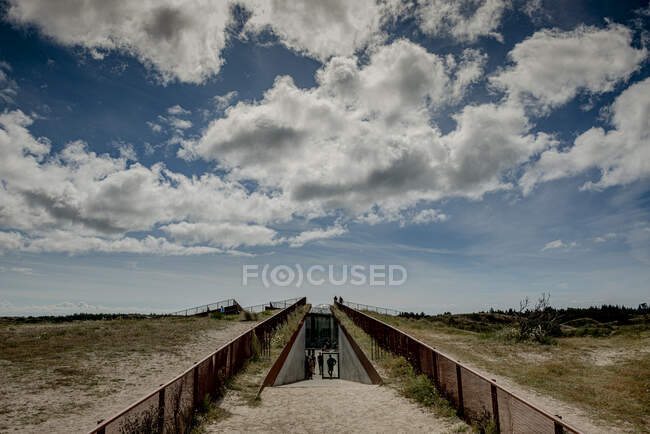Nubes sobre la pasarela de la playa - foto de stock