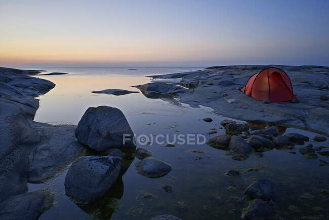 Barraca em rochas por mar — Fotografia de Stock