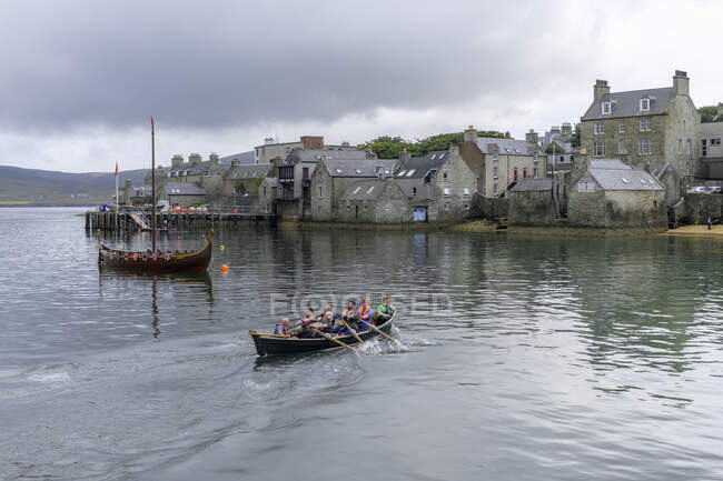People rowing boat at cloudy day — Stock Photo