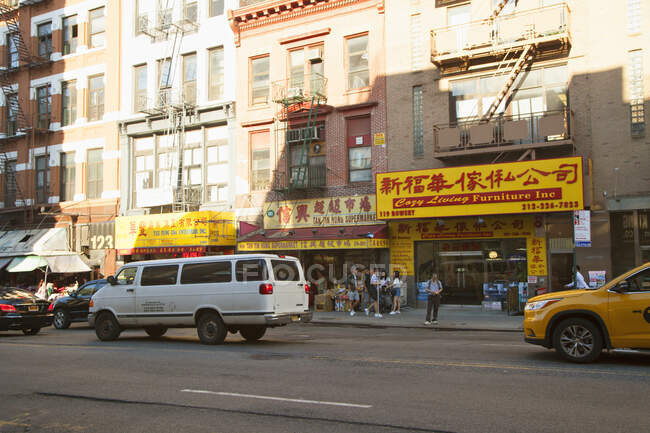 Autos auf der Straße und Geschäfte in Chinatown, New York — Stockfoto