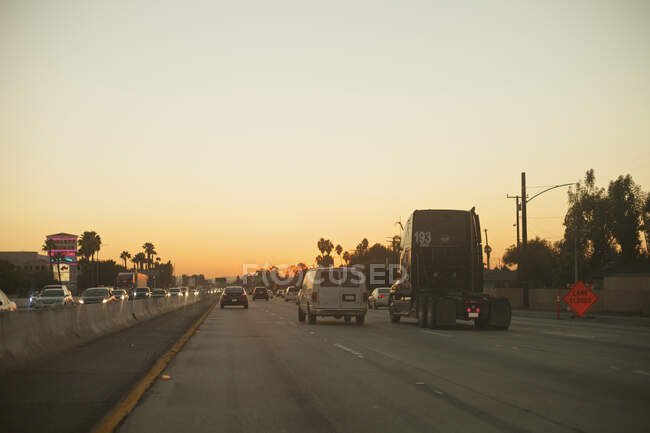 Cars and truck driving on 101 Freeway at sunset in Los Angeles, California — Stock Photo