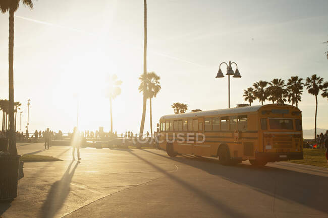 Bus driving by Venice Beach during sunset — Stock Photo