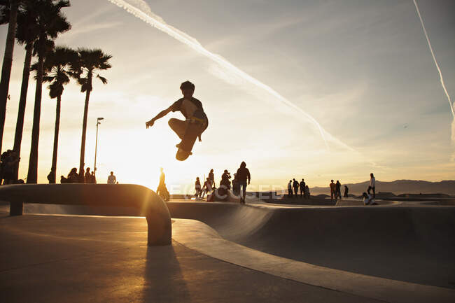 Teenager skaten bei Sonnenuntergang im Skatepark — Stockfoto
