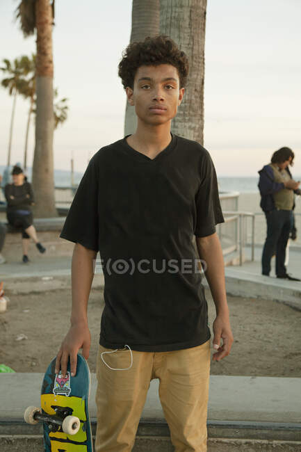 Teenage boy with skateboard at skatepark — Stock Photo