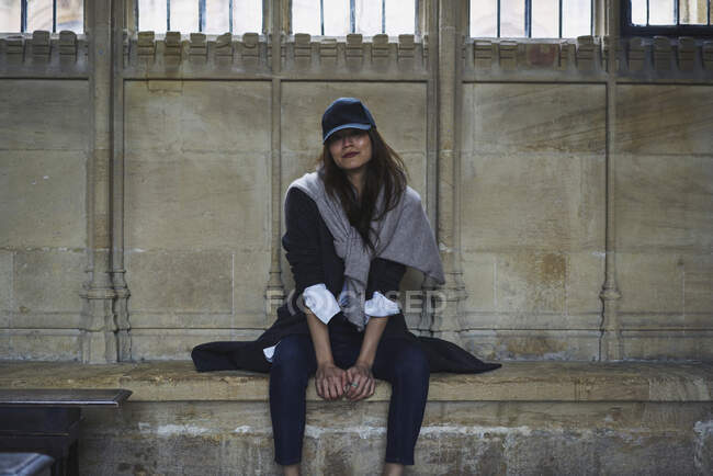 Donna in berretto seduta sulla panchina — Foto stock