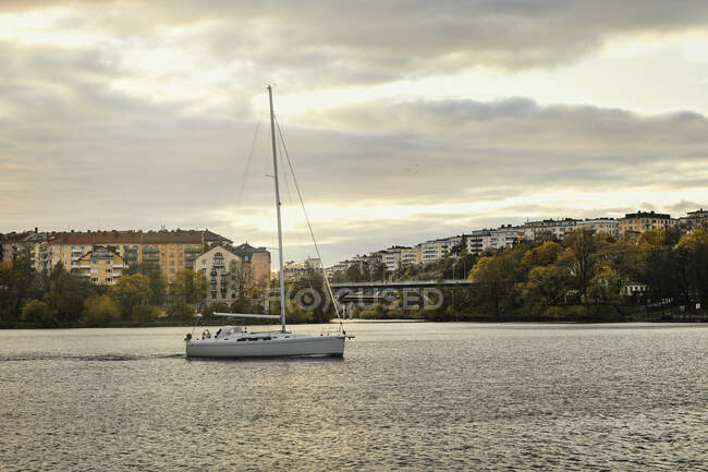 Yacht in harbor during sunset — Stock Photo