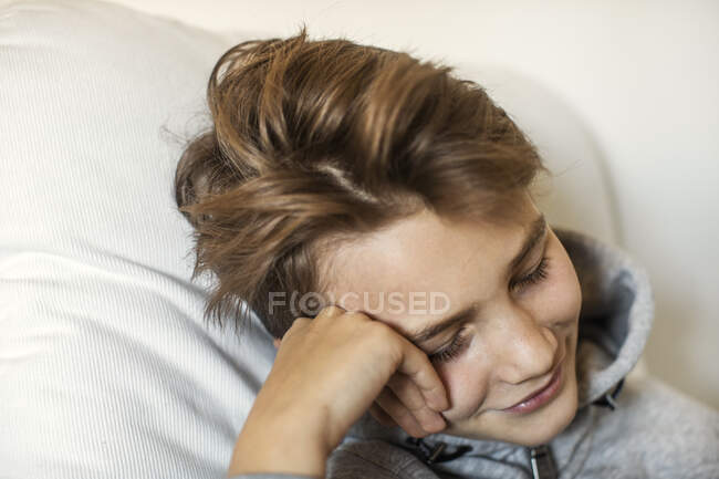 Smiling boy sitting on chair — Stock Photo