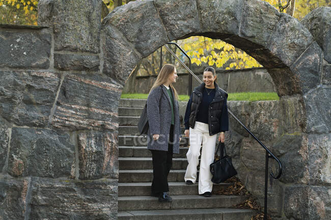 Young women walking on steps — Stock Photo