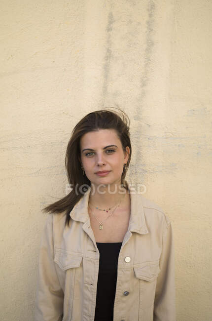 Portrait of young woman in beige coat — Stock Photo