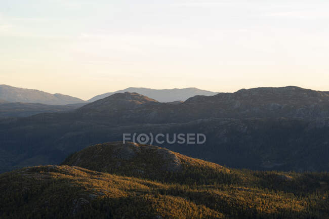 Mountain in shadow at sunset — Stock Photo