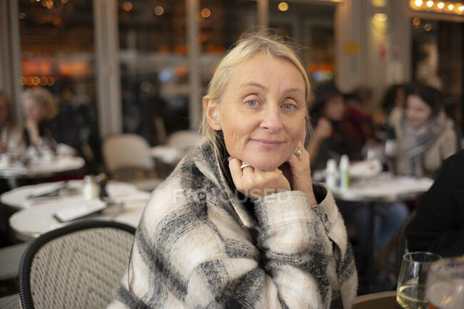Mature woman sitting at cafe — Stock Photo