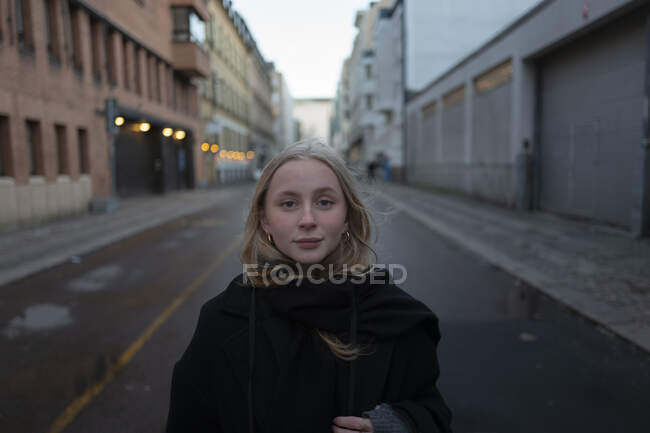 Teenage girl standing on street in city — Stock Photo