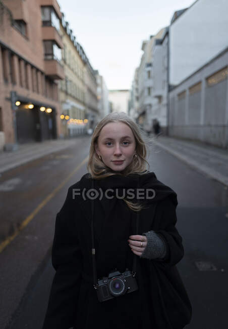 Teenage girl standing on street in city — Stock Photo