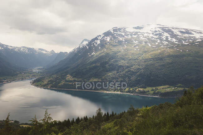 Clouds above mountain and fjord — Stock Photo