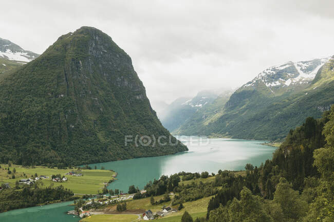 Clouds above mountain and lake — Stock Photo