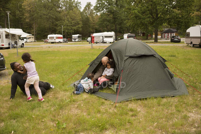 Family with tent while camping — Stock Photo
