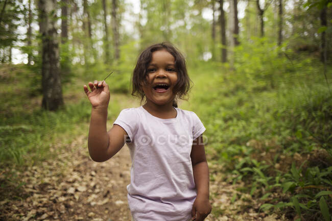 Sonriente chica senderismo en el bosque - foto de stock