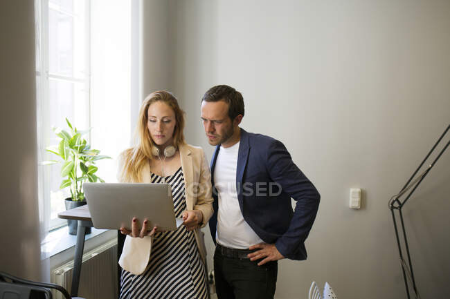 Coworkers with laptop in office — Stock Photo