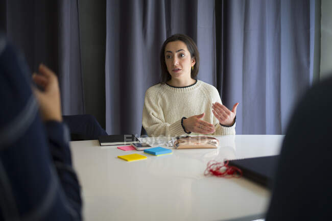 Young woman talking during meeting in office conference room — Stock Photo