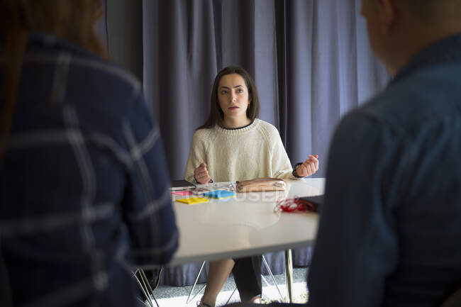 Young woman talking during meeting in office conference room — Stock Photo