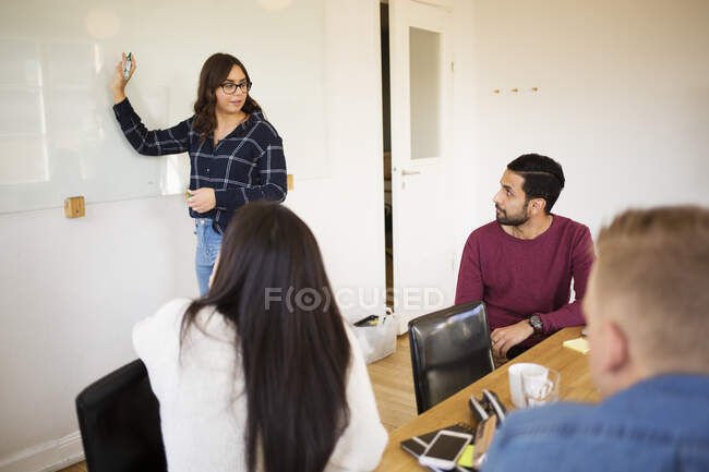 Woman giving presentation in conference room — Stock Photo