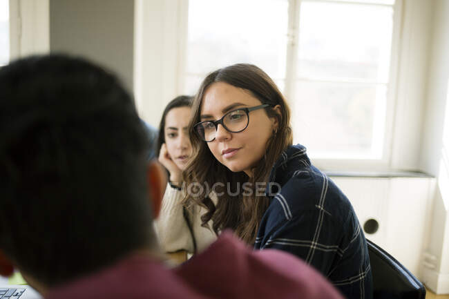 Mulher ouvindo colega durante reunião — Fotografia de Stock