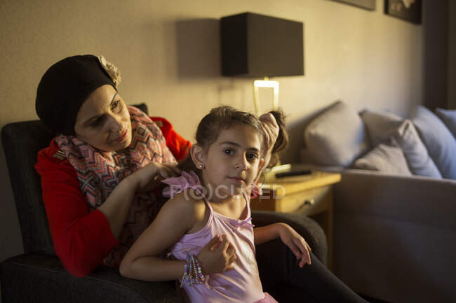 Женщина завязывает дочери волосы в хвостик — стоковое фото