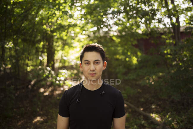 Portrait of young man in forest — Stock Photo