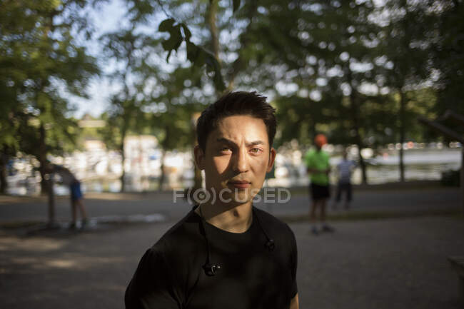 Portrait of young man in park — Stock Photo