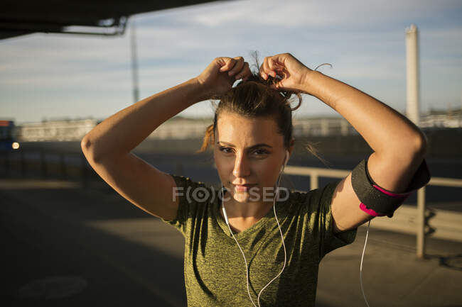 Young woman adjusting her hair — Stock Photo
