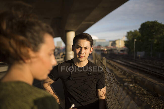 Young man and woman under bridge — Stock Photo