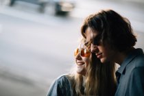 Stylish young couple in glasses at street scene — Stock Photo