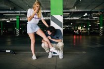 Young man applying adhesive plaster on girlfriend's knee — Stock Photo