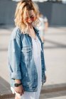 Young adult woman in casual clothing in cityspace — Stock Photo