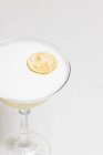 Крупный план коктейля с пеной и сушеным ломтиком лимона — стоковое фото