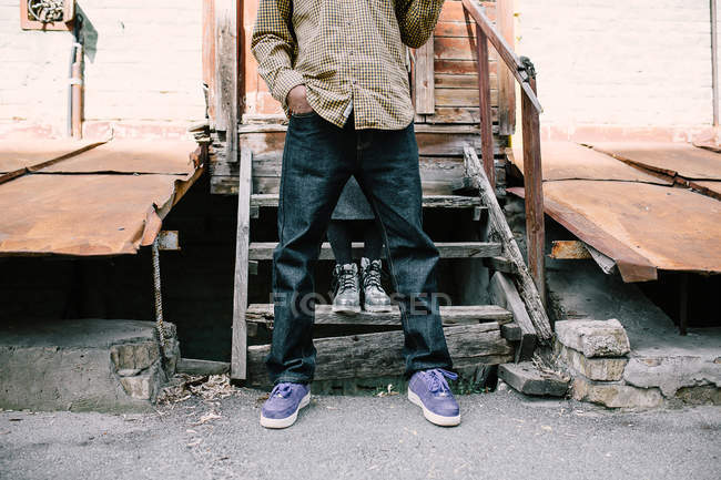 Mann im karierten Hemd posiert über Holztreppe — Stockfoto