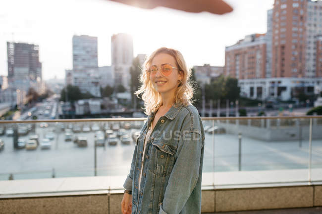 Young adult woman in casual clothing in cityspace — Stock Photo