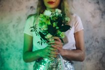 Portrait of young woman with bridal bouquet — Stock Photo