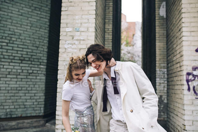 Молода пара обіймає і сміється на міській вулиці — стокове фото